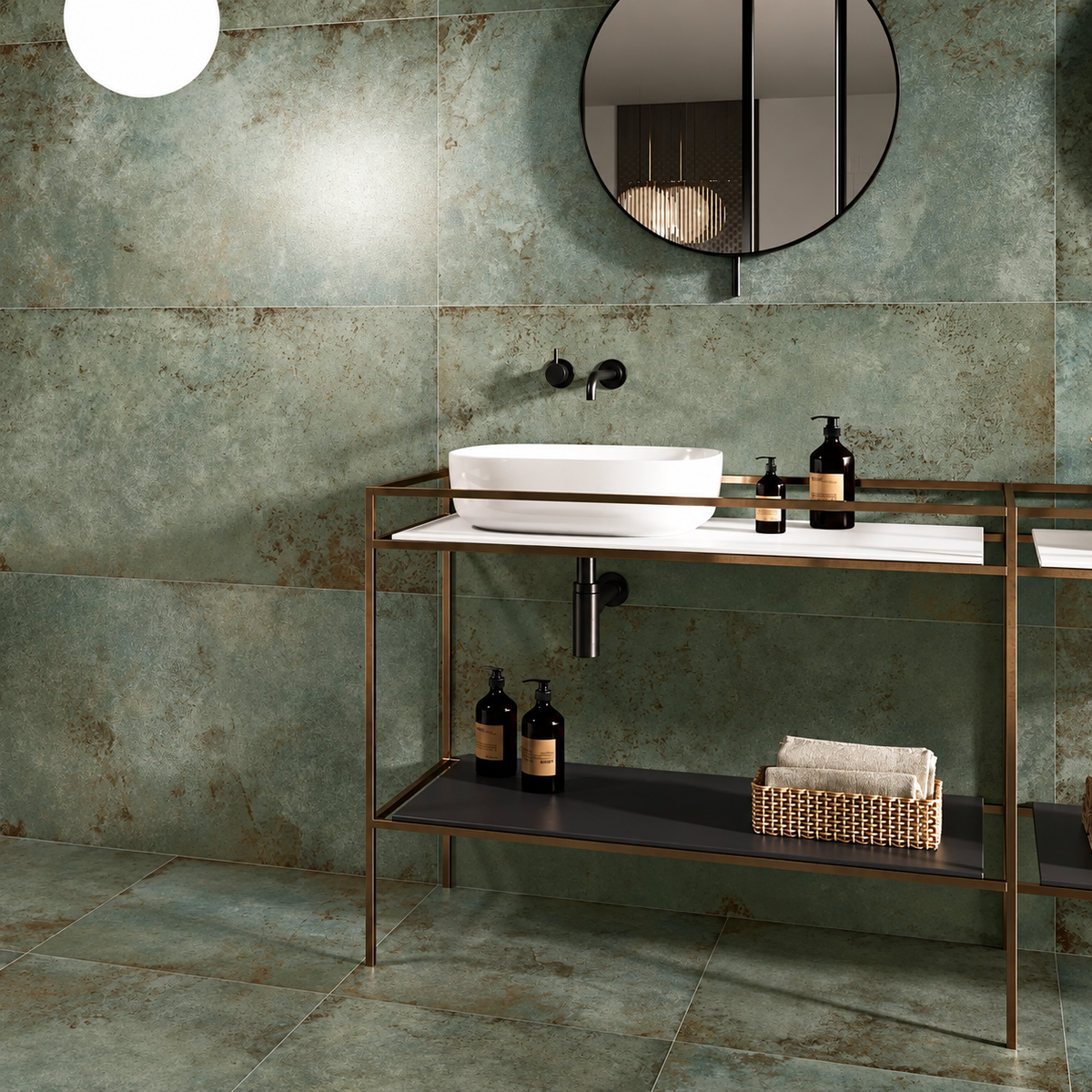 Weathered green porcelain walls and floor surrounding a white basin on a bronze-framed bathroom console.
