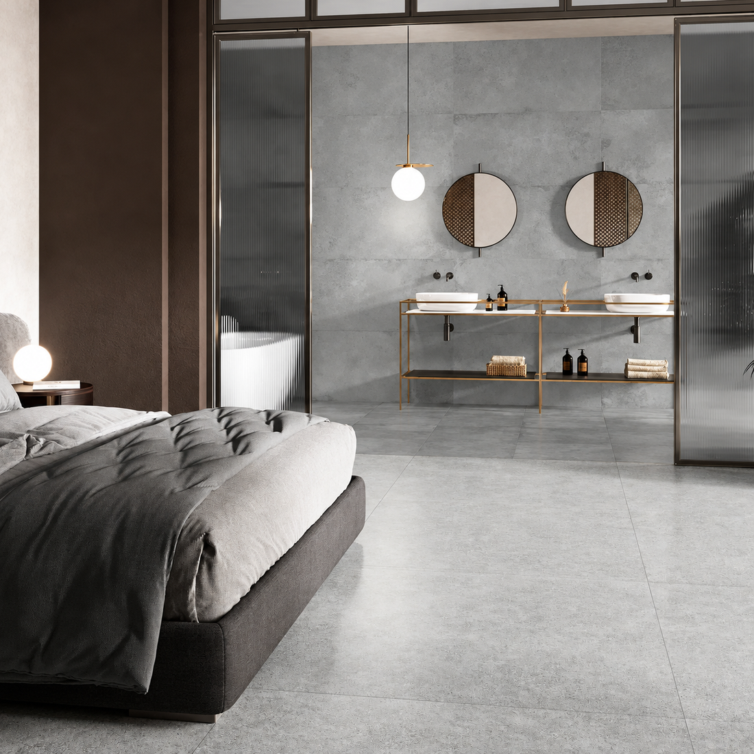 Alloy Pearl grey metal effect porcelain tiles in a bedroom and adjoining en-suite with twin basins and brass fittings.