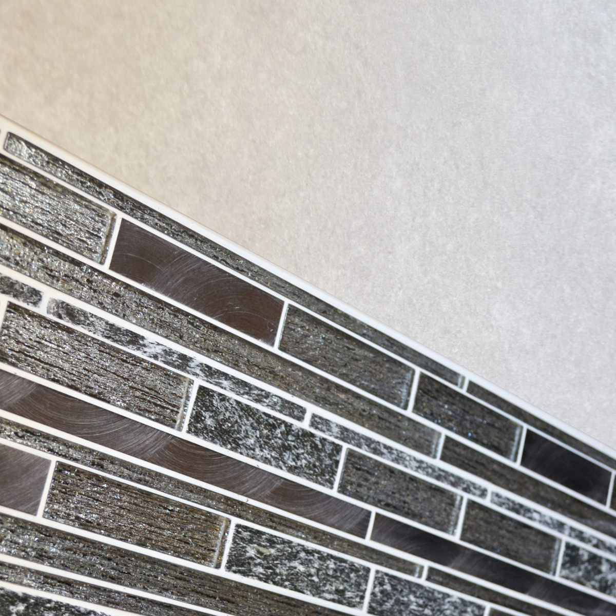 Black glass, stone and brushed metal mosaic tiles 