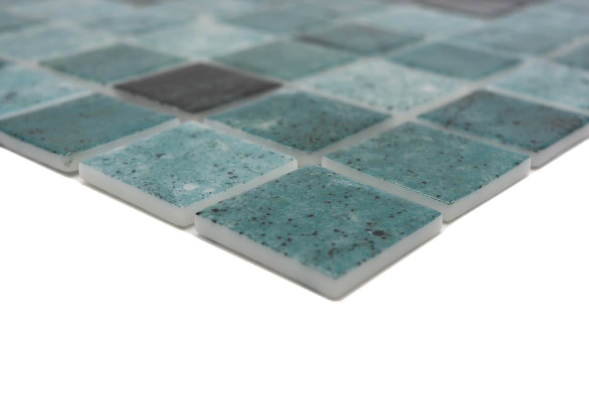 Emerald green glass pool mosaic tiles creating natural resort-style water effect