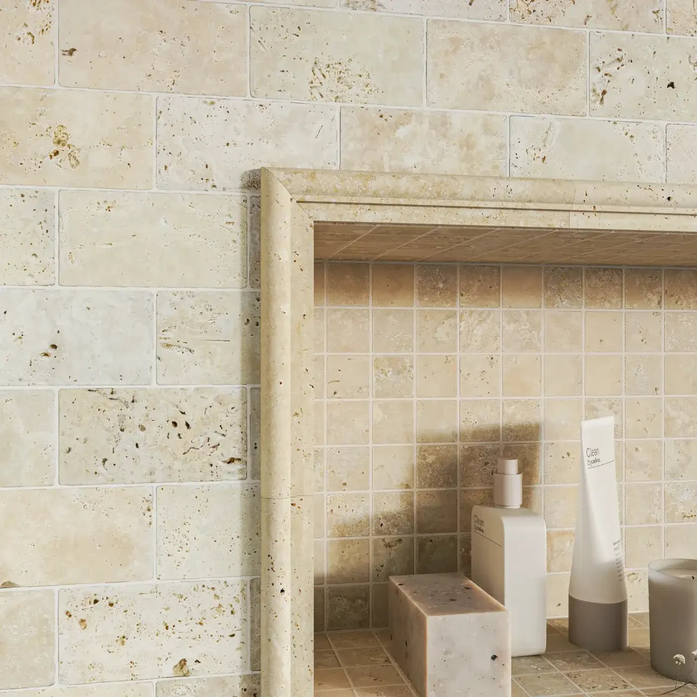 cream travertine border tile in bathroom niche 