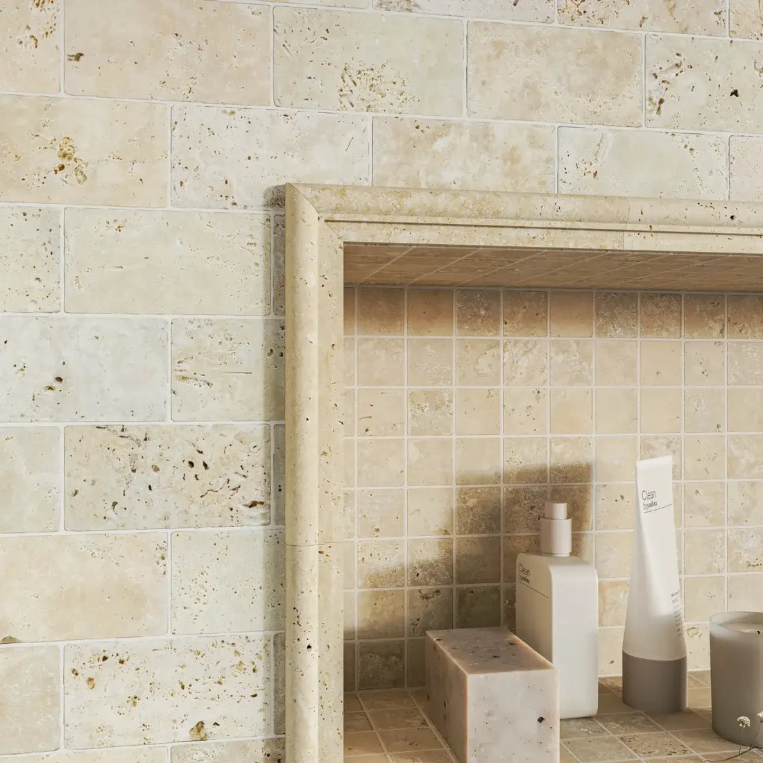 cream travertine border tile in bathroom niche 