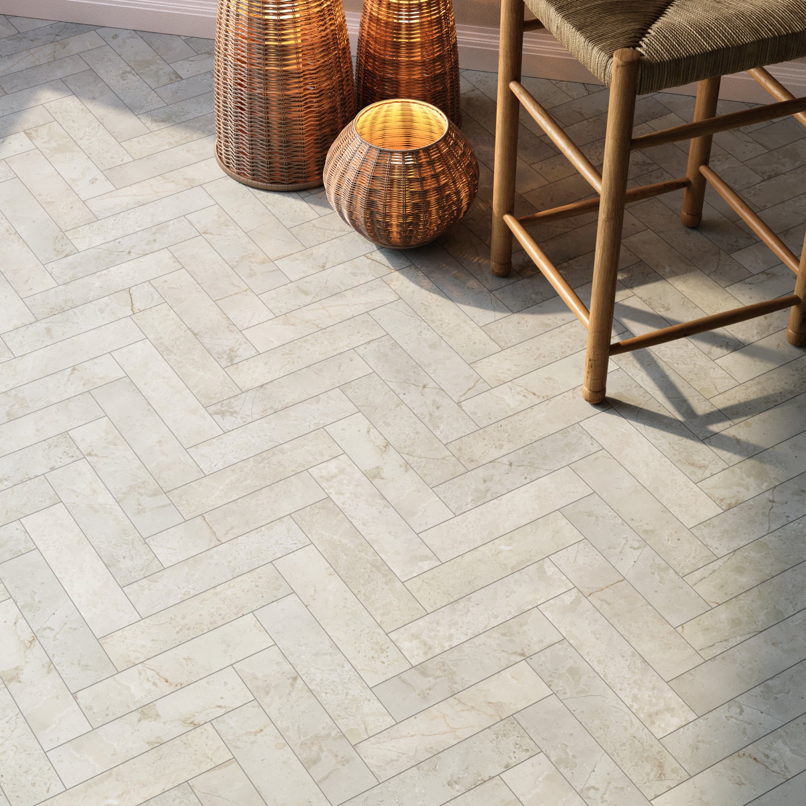 Natural beige marble herringbone floor tiles in a honed finish, showing soft veining, micro bevelled edges and classic parquet pattern