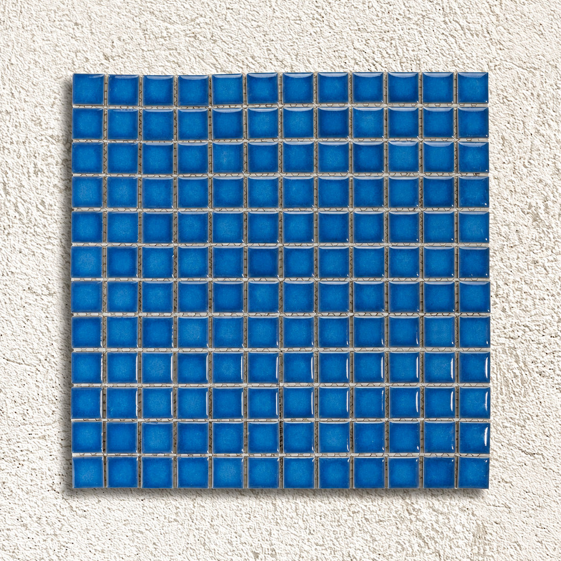 Ceramic Pool Baltic Blue Mosaic Tiles showing glossy 23mm blue porcelain squares with darker edges on a mesh-backed sheet.