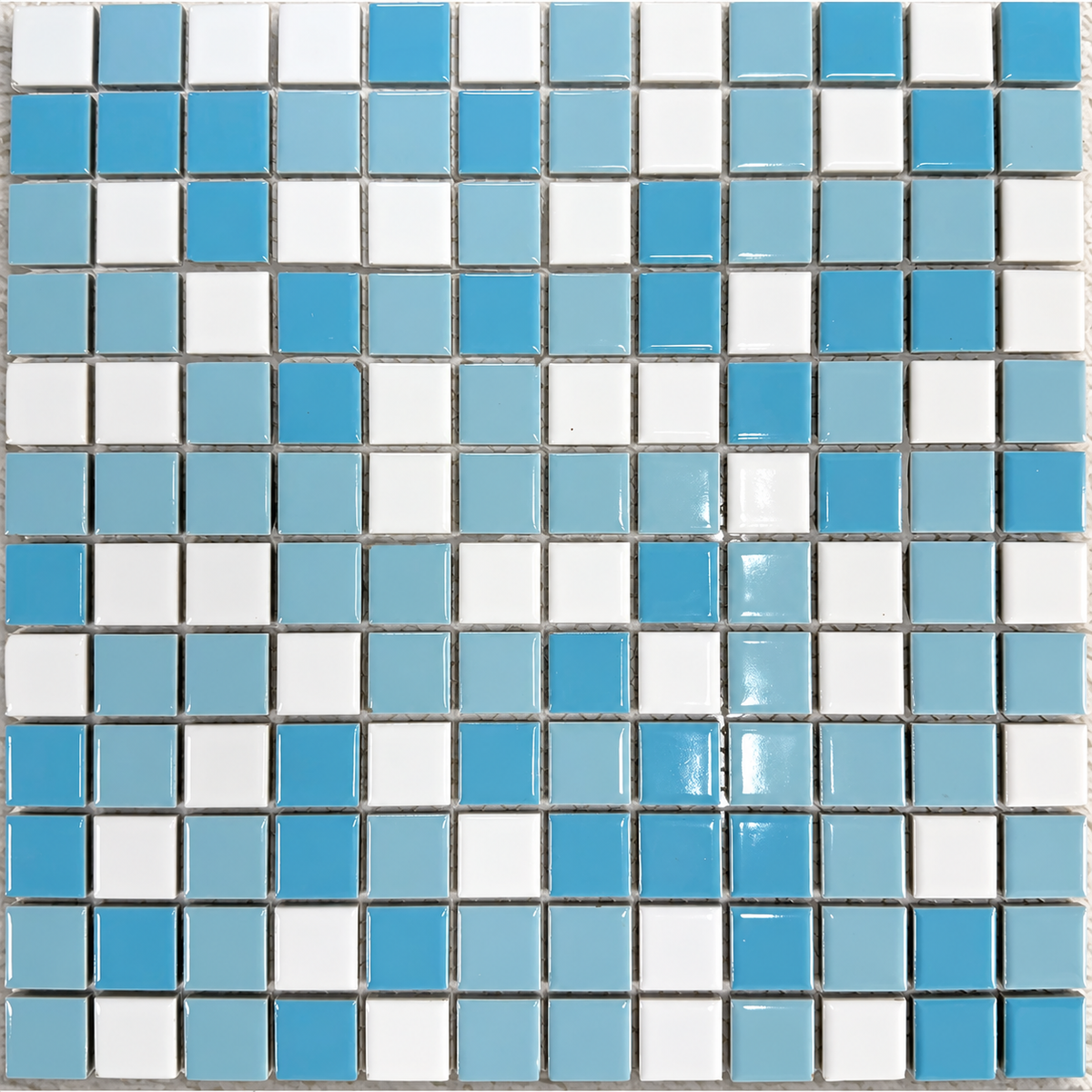 Ceramic Pool Caribbean Mosaic Tile showing glossy blue, pale blue and white 23mm porcelain squares on a mesh-backed sheet.