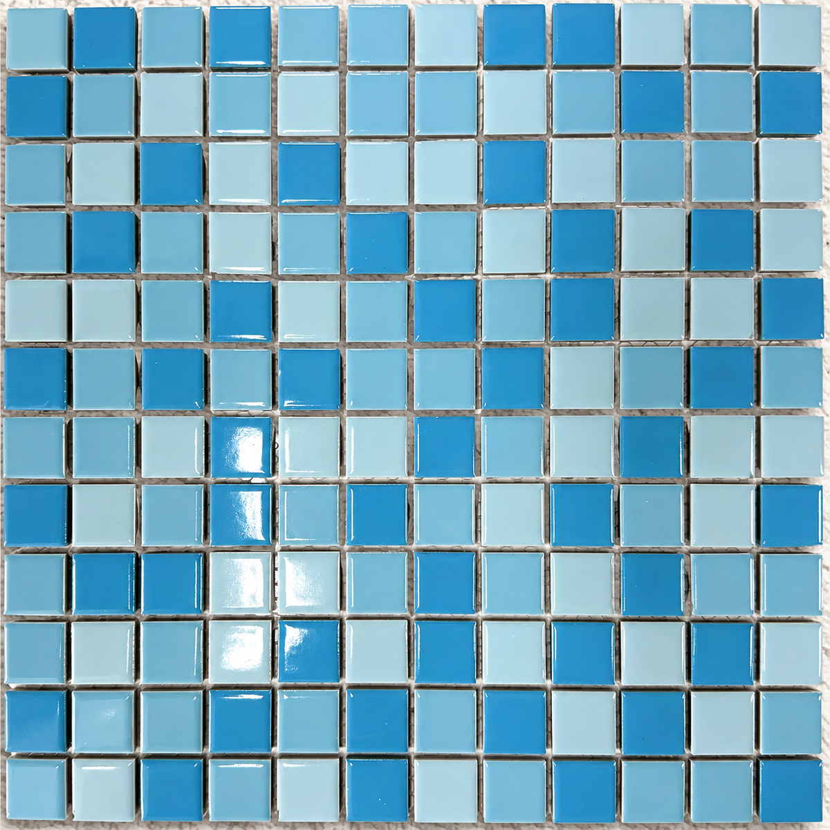 Swimming pool with curved steps clad in blue Ceramic Pool Mediterranean mosaic tiles and contrasting white edging.