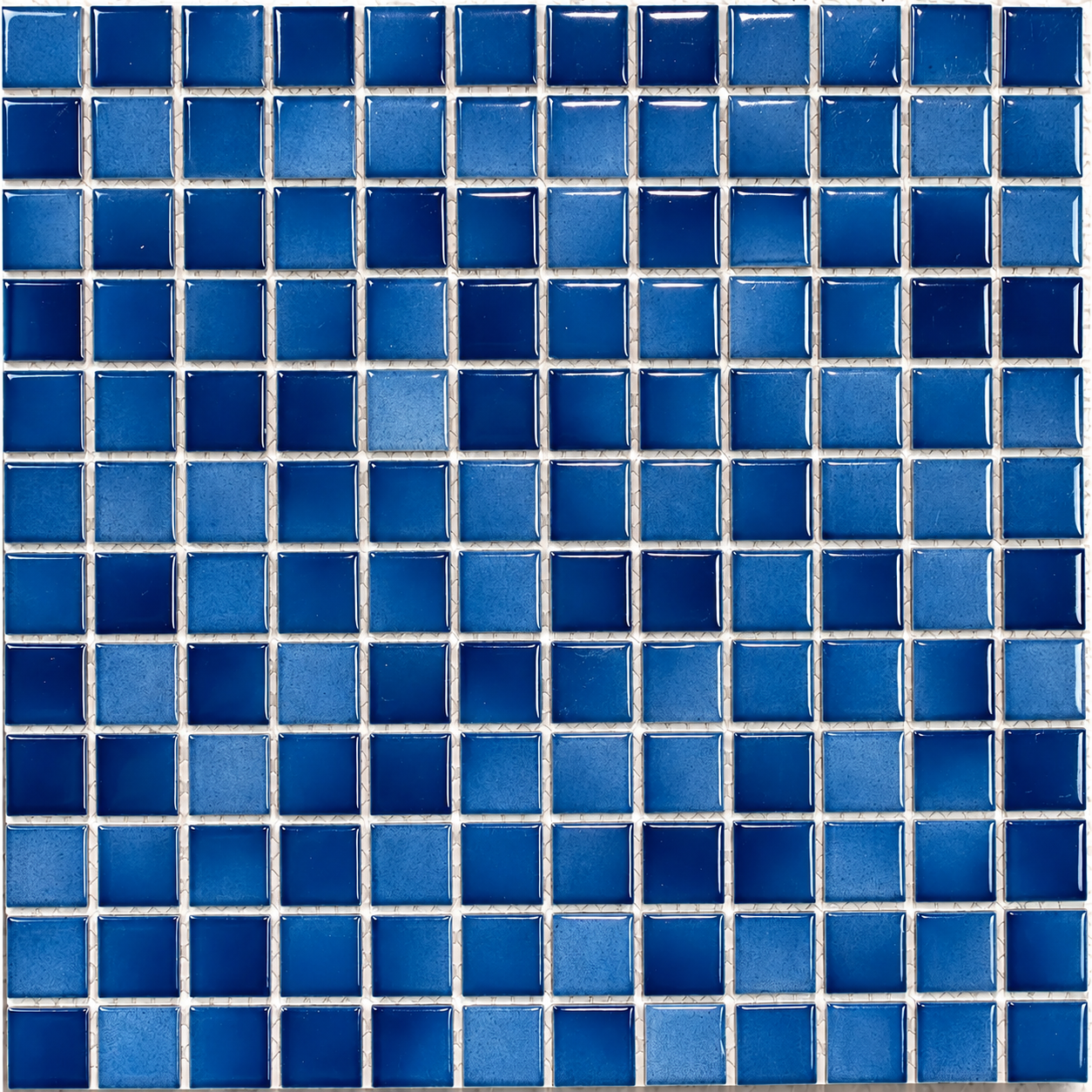 Close-up of Ceramic Pool Ocean Mosaic Tile showing 23mm blue squares with glossy highlights and subtly mottled surfaces.