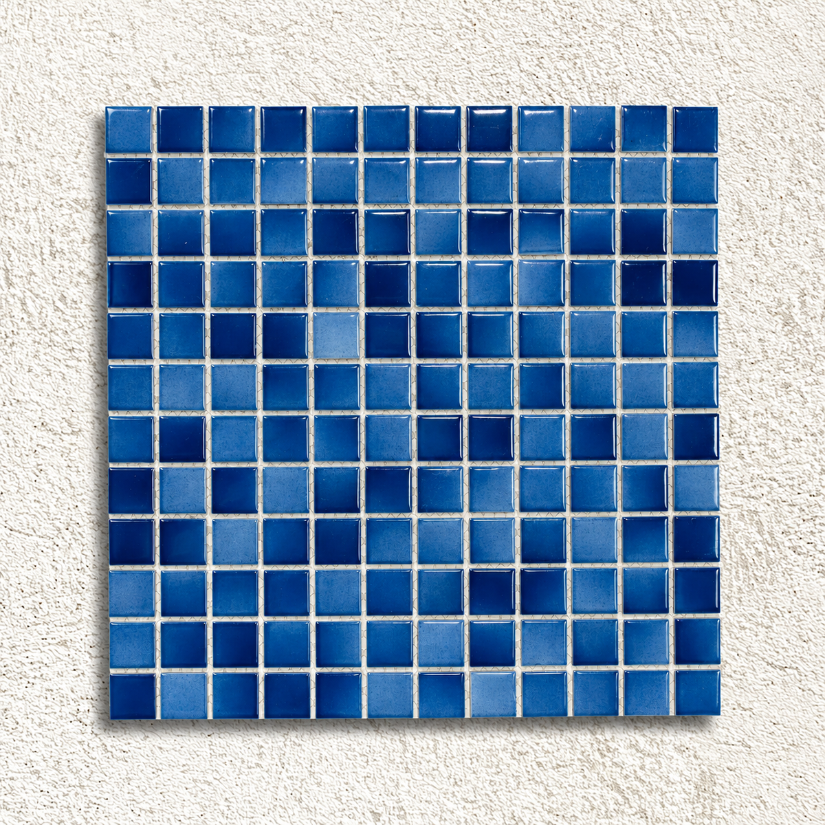 Ceramic Pool Ocean Mosaic Tile sheet with glossy navy and mid-blue porcelain squares against a textured white background.