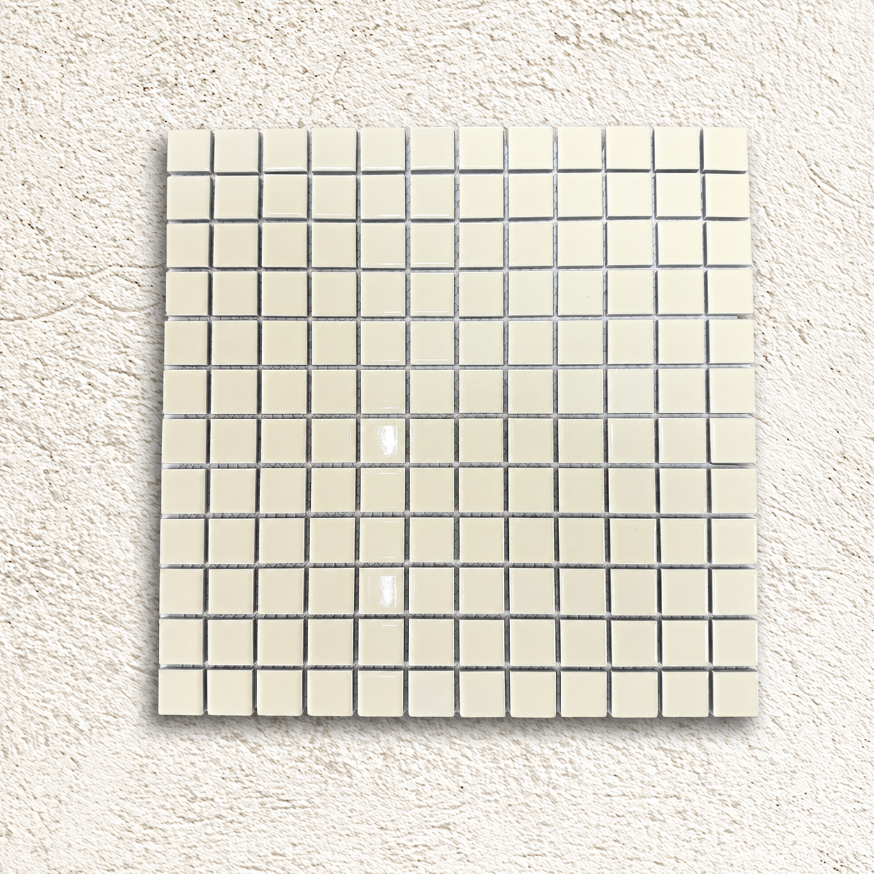 Ceramic Pool Vanilla Mosaic Tile sheet with glossy ivory porcelain squares on a pale textured background.