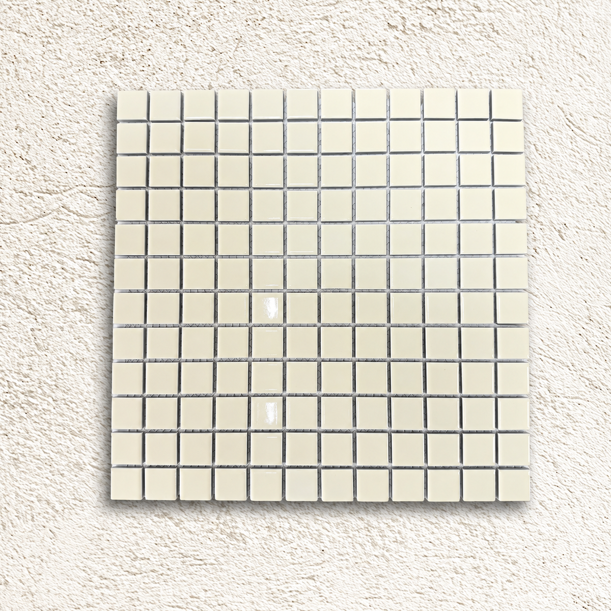 Ceramic Pool Vanilla Mosaic Tile sheet with glossy ivory porcelain squares on a pale textured background.