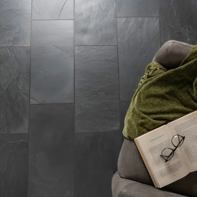 Country farmhouse black slate floor tiles in a living room setting with natural riven texture and dark charcoal tones.