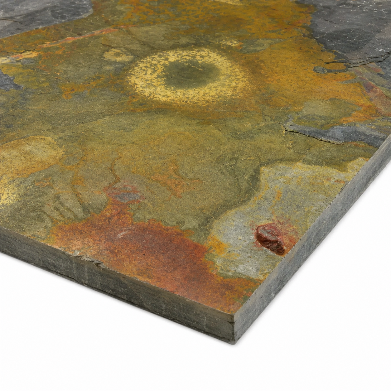 Side profile of natural multicolour slate tile showing riven surface, varied colouring and stone thickness.