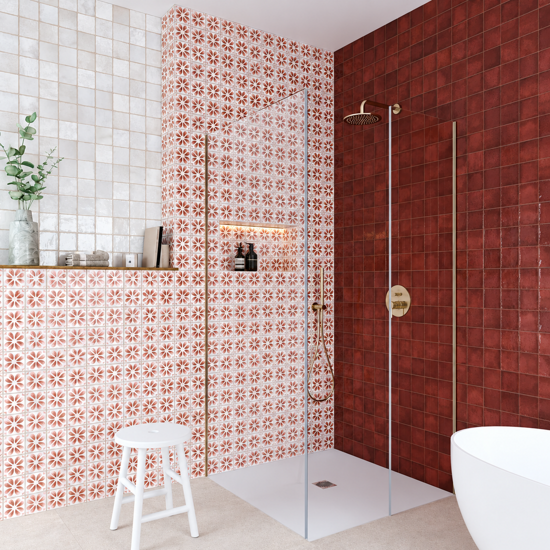 Rose-patterned porcelain feature wall beside a burgundy shower wall, with brass fittings and a clear glass screen.