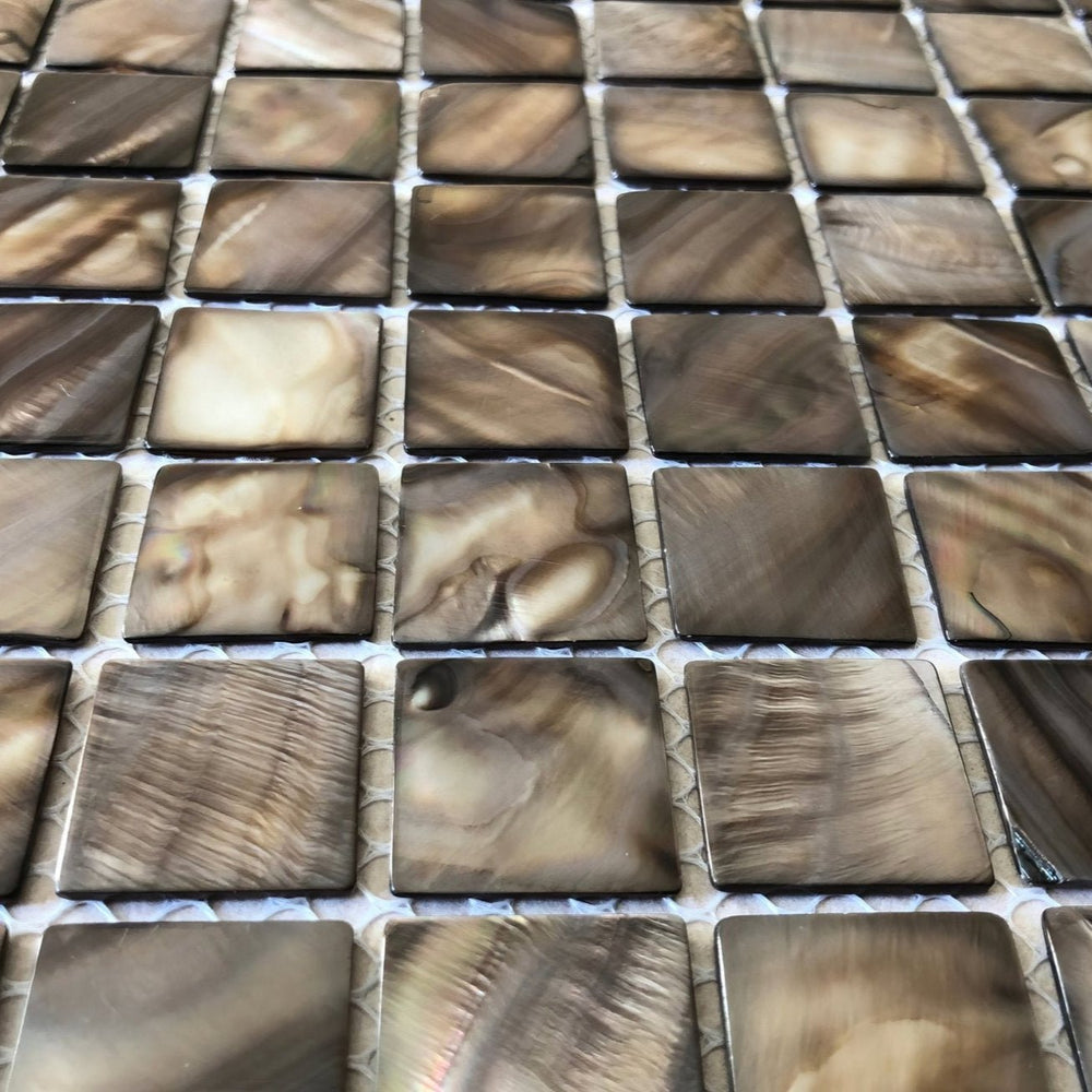 Close-up of dove grey shell mosaic tiles with soft iridescent finish and subtle brown undertones