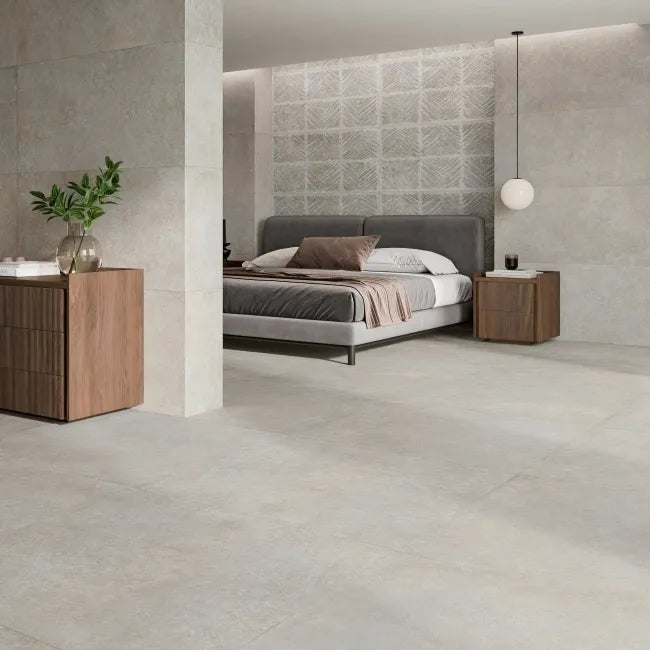 Driftwood Pale Grey 995x995mm concrete-style porcelain floor tiles in a modern kitchen with walnut cabinetry and green dining chairs
