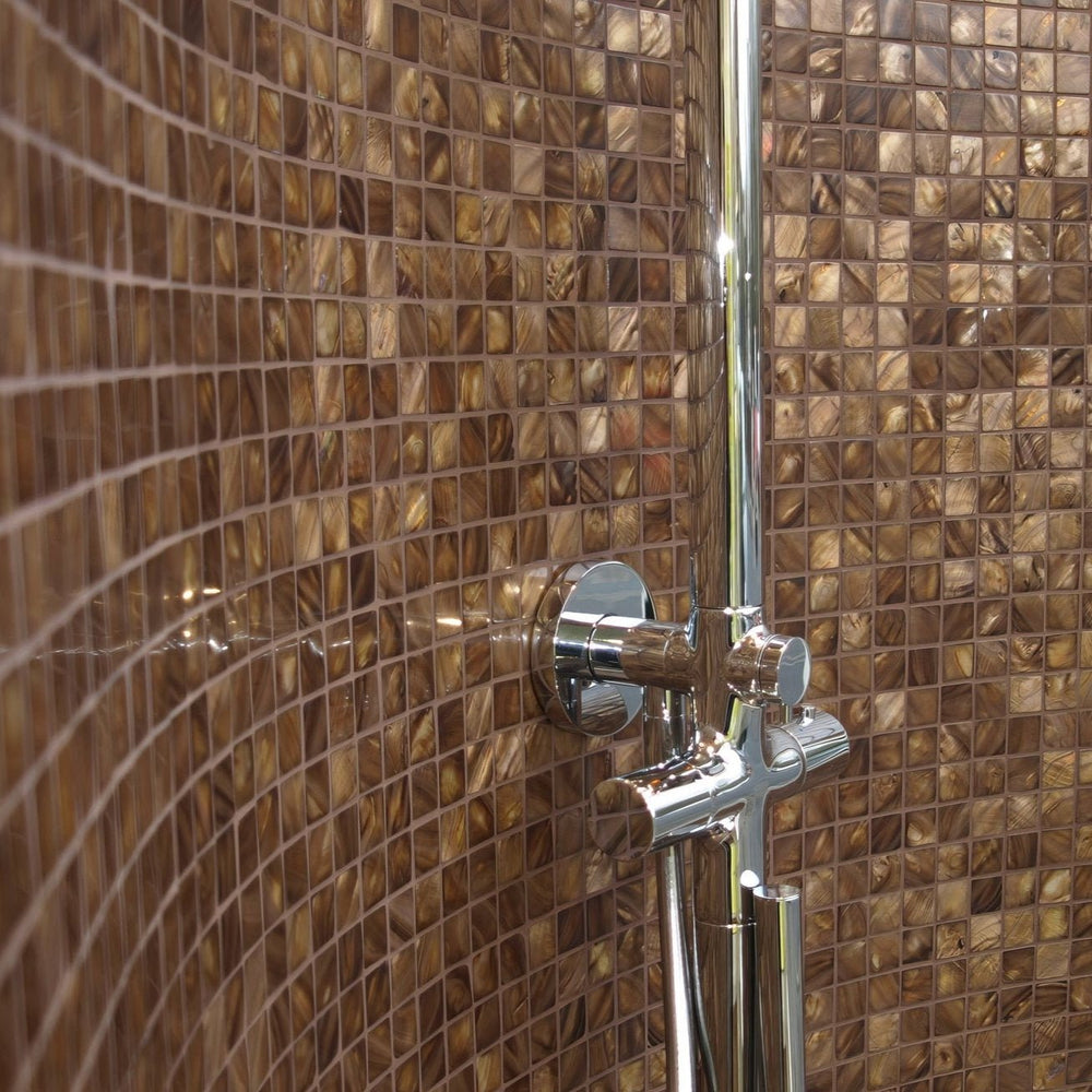 Gentle Earth mother of pearl mosaic tiles installed on bathroom wall with warm brown tones and reflective finish