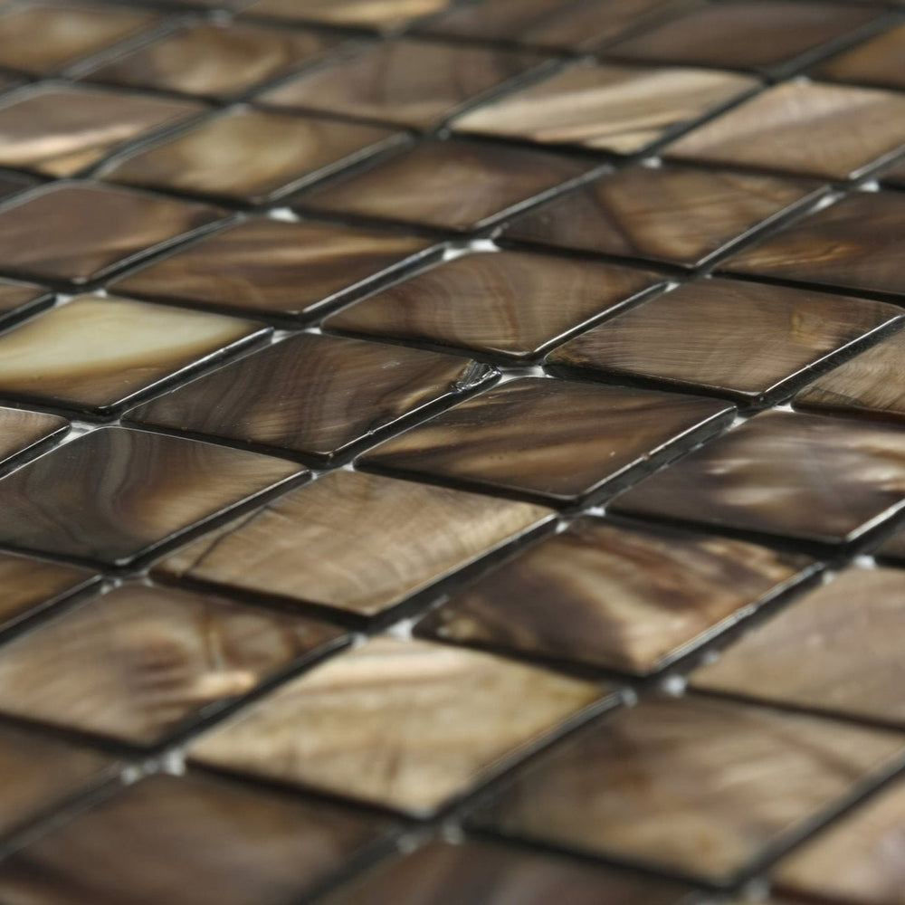 Close-up detail of Gentle Earth shell mosaic tiles highlighting 25mm square format and gloss surface texture