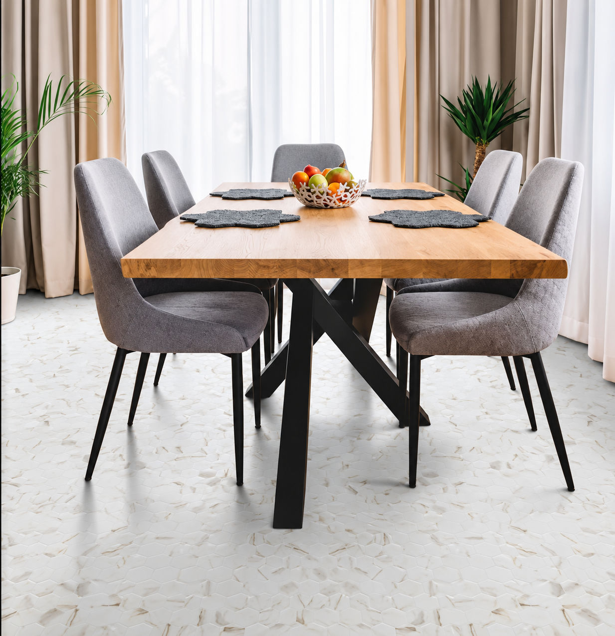Calacatta Gold matt hexagon mosaic floor beneath a wooden dining table with grey upholstered chairs.