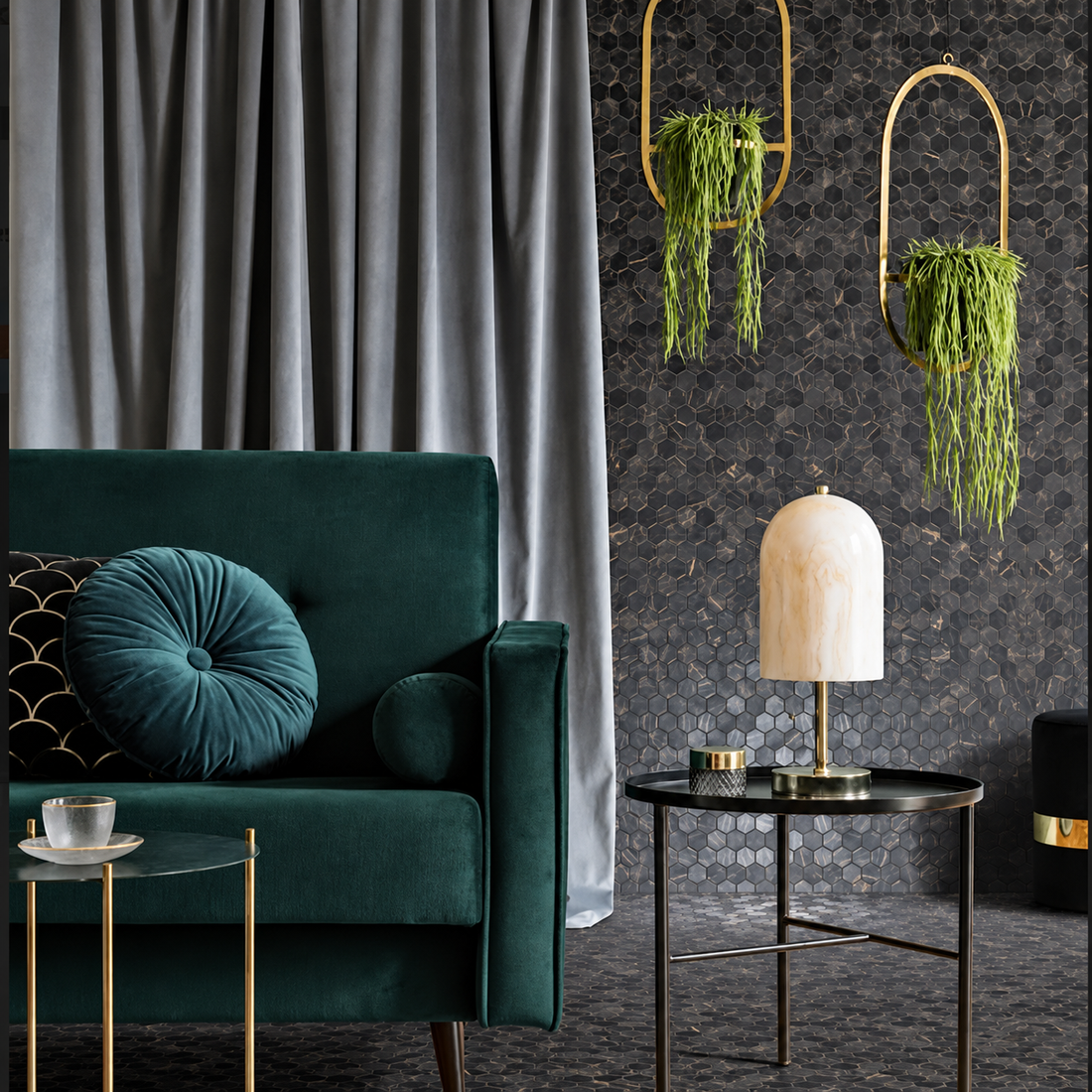 Hex XL Coimbra dark marble-effect hexagon mosaic wall and floor beside a green velvet chair and brass-accented décor.