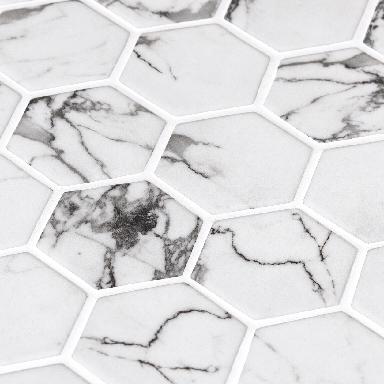Close-up of Hex XL Fosco matt hexagon mosaic tiles showing grey veining and white grout joints.