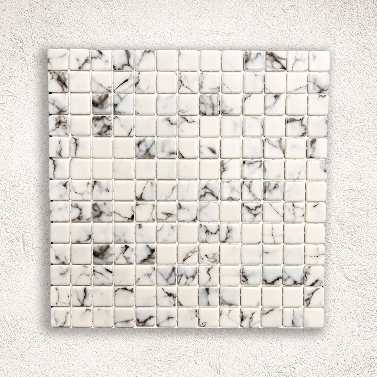 Karma Calacatta gloss glass mosaic sheet with 25mm white square pieces and grey marble effect veining.