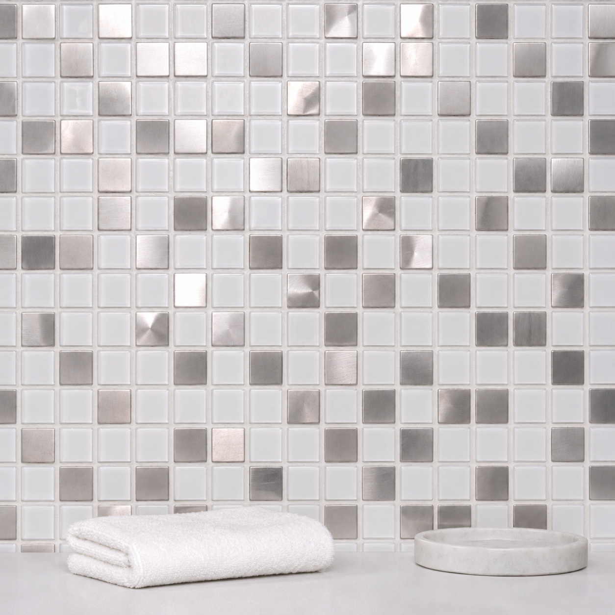 Kensington White Glass & Silver Metal Mosaic Tile installed behind a bathroom countertop with light grout and minimal décor