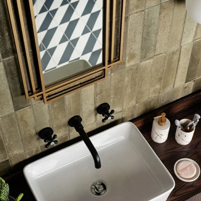 Mandarin Antique Olive Gloss Metro tiles installed vertically around a bathroom basin with black brassware and dark wood vanity.