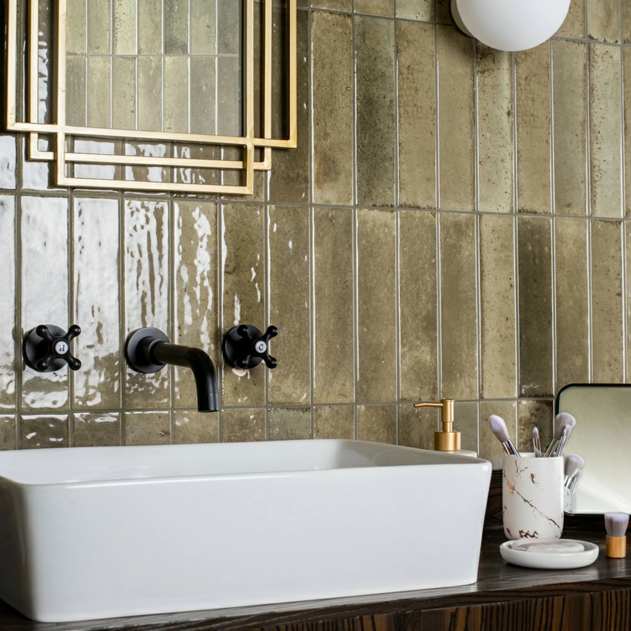 Antique olive gloss metro bathroom wall tiles in a vertical layout, showing natural colour variation and high-shine glaze.
