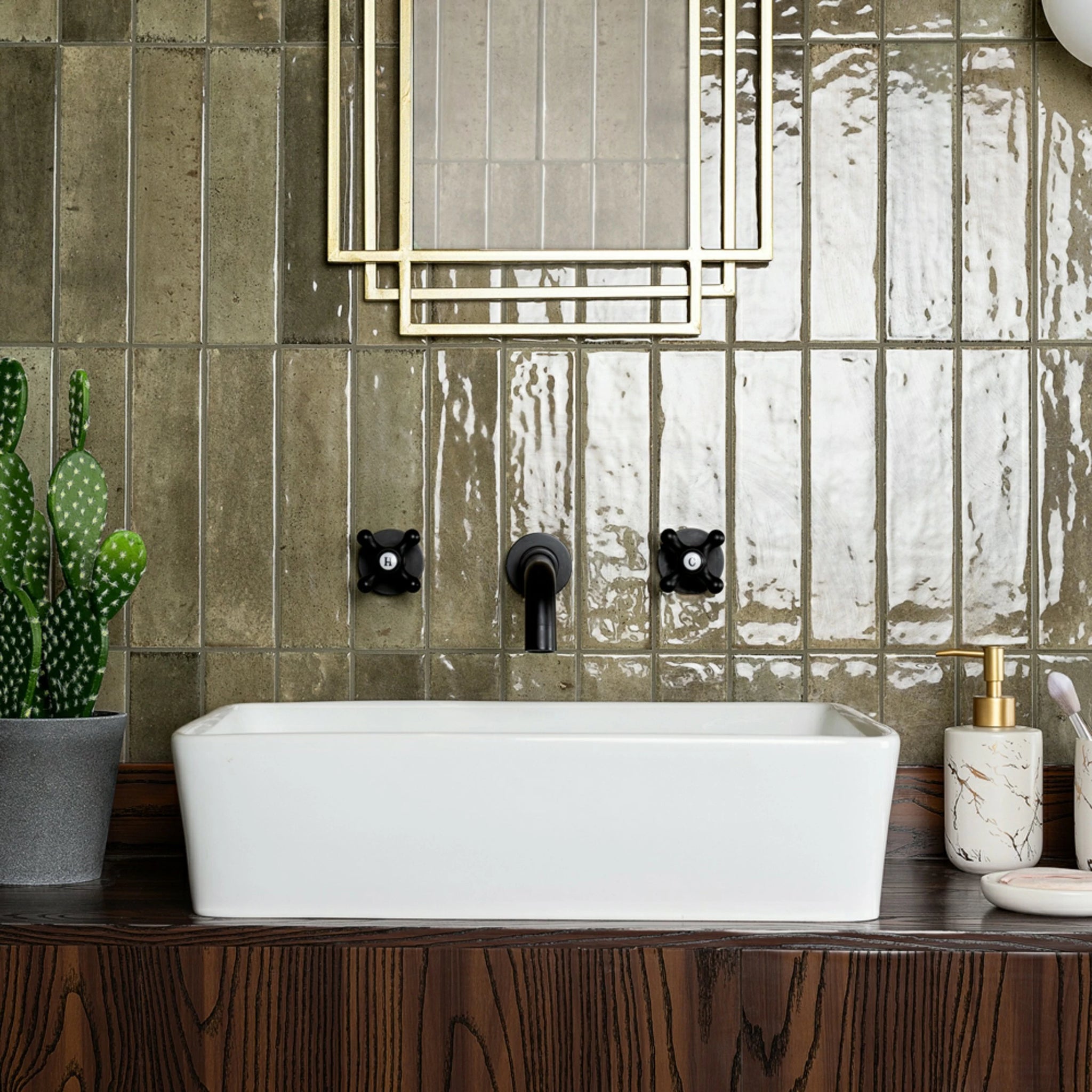 Mandarin Antique Olive Gloss Metro 60x250mm tiles installed vertically behind a bathroom basin with a reflective glazed finish.