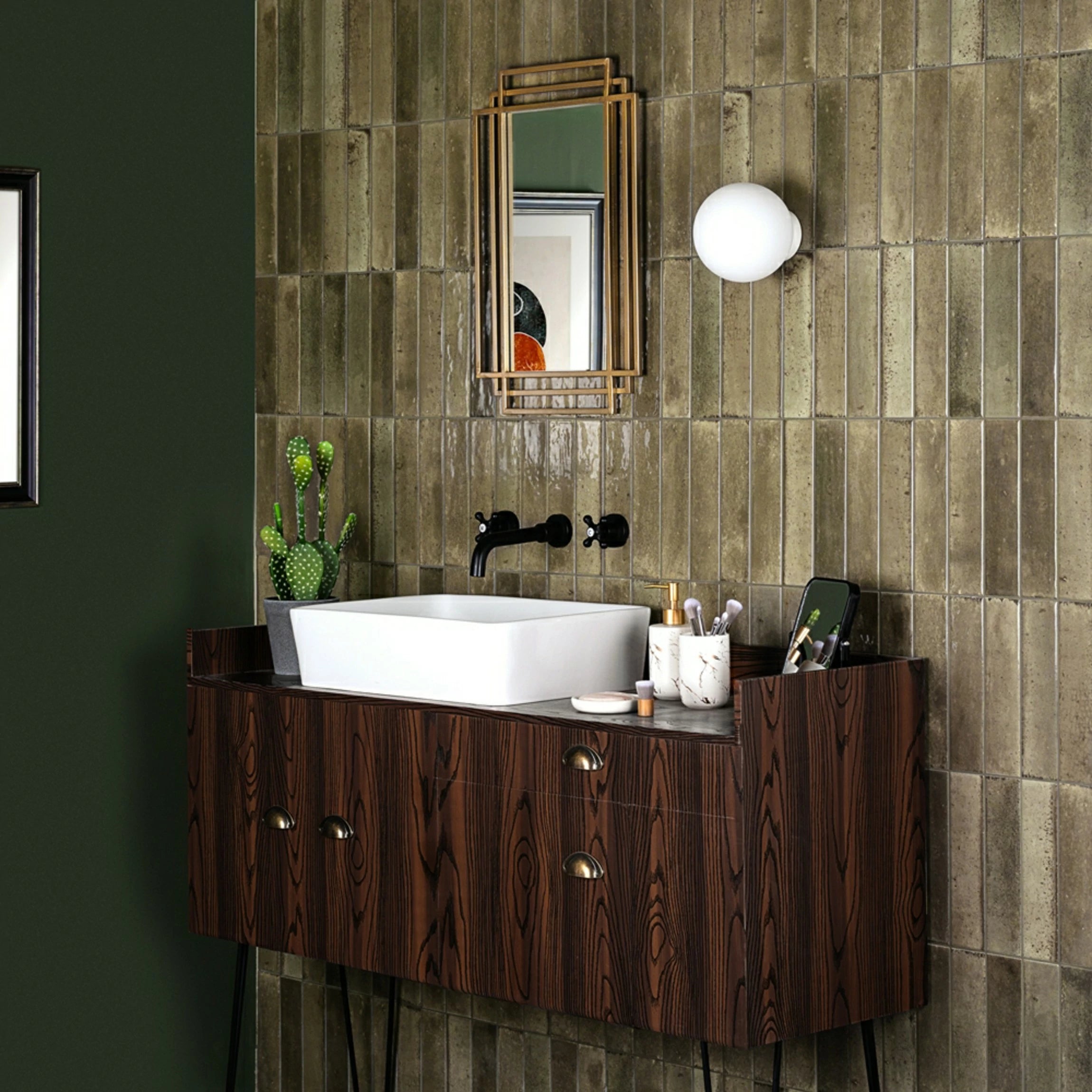 Mandarin Antique Olive Gloss Metro 60x250mm ceramic wall tiles installed vertically in a bathroom, showing warm olive taupe tonal variation and a reflective glazed finish.