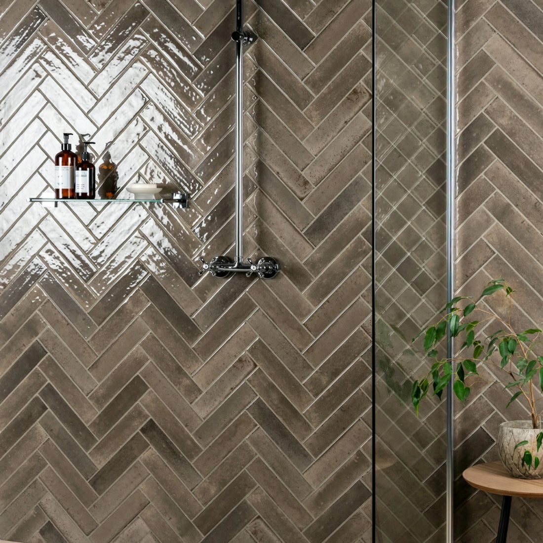 Brown herringbone chevron wall tile in a modern shower setting 