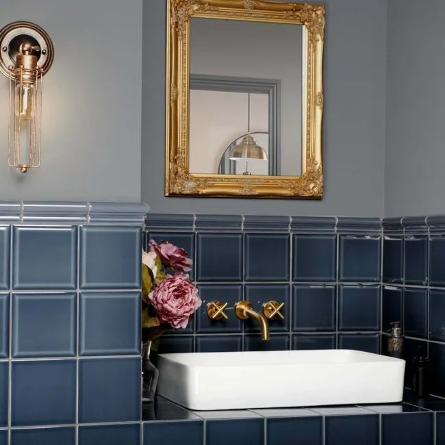 Dark blue bathroom setting sink surround tiles 