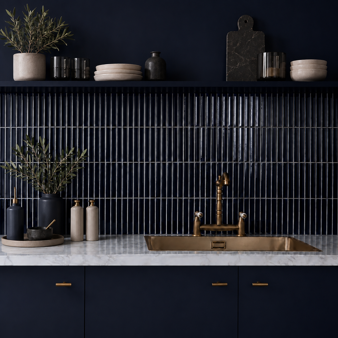 Midnight navy gloss KitKat ceramic mosaic kitchen splashback with slim 20 x 145 mm vertical tiles, 2 mm grout joints, navy cabinetry, marble worktop, brass sink tap an