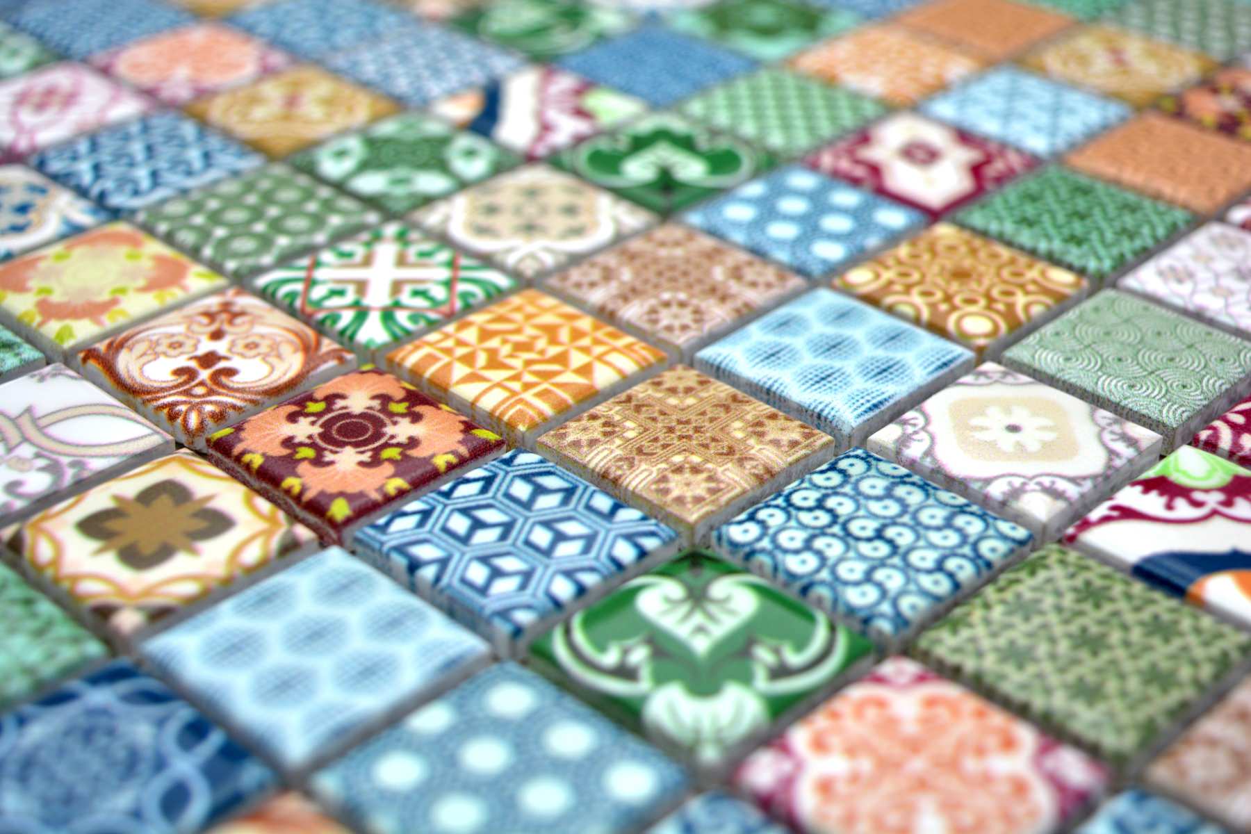 Close-up of Moroccan patterned ceramic mosaic tiles showing glossy decorative prints, raised square chips and mixed retro colours.