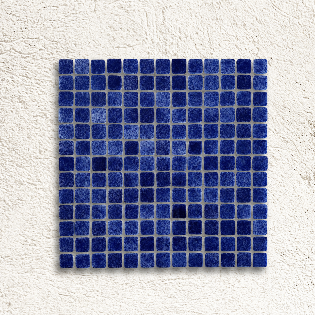 Niebla Foggy Dark Blue glass mosaic sheet with 25mm mottled navy squares against a white textured background.