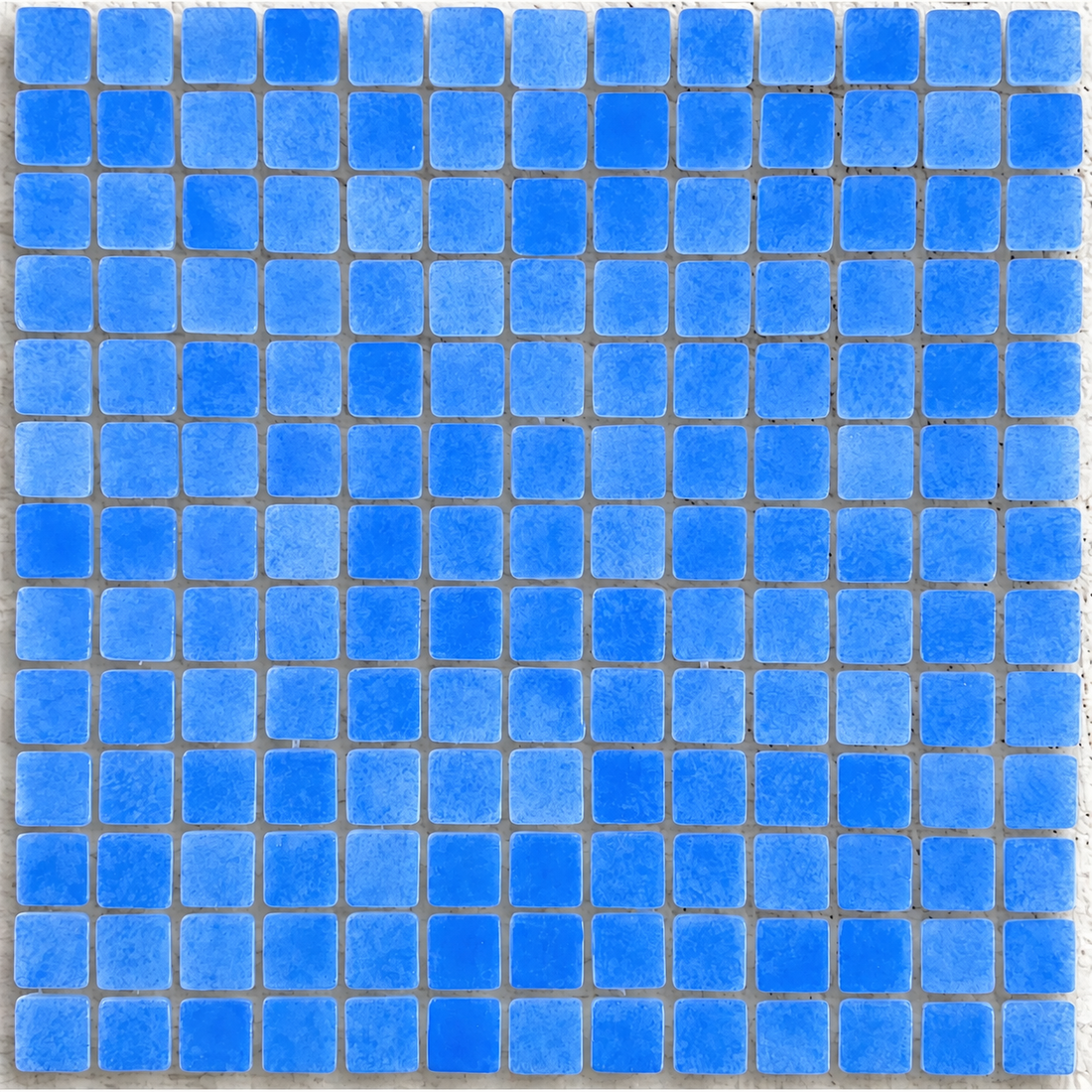 Detail of Niebla Foggy Mid Blue gloss glass mosaics showing mottled blue tones, rounded square edges and evenly spaced joints.