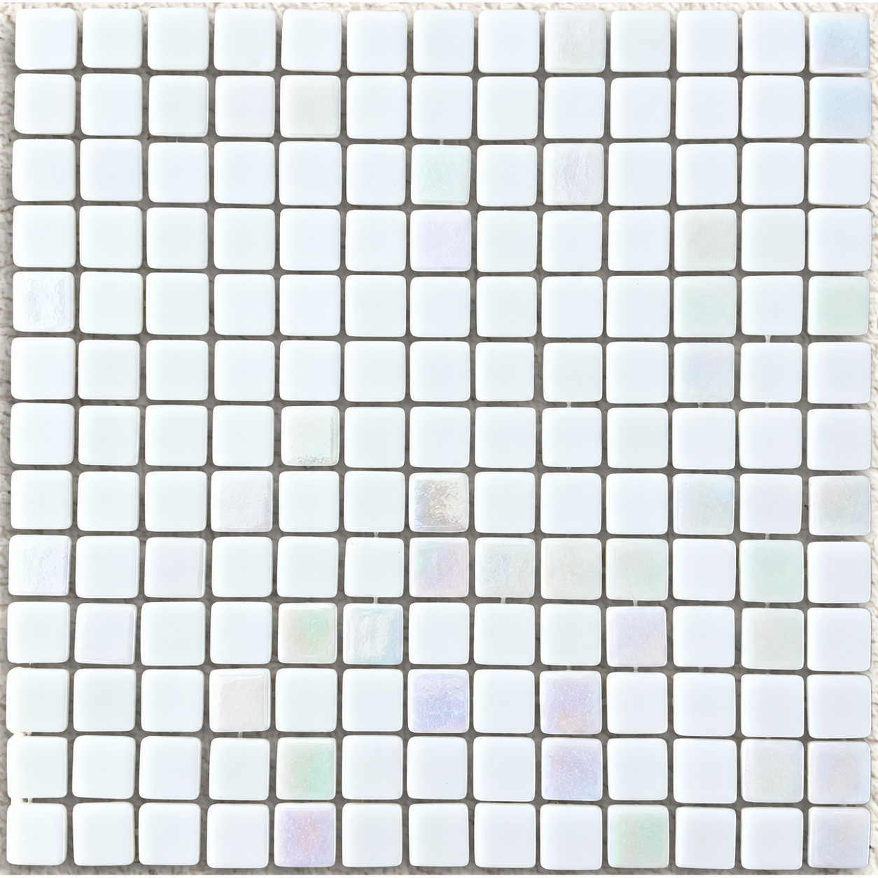 Close-up of Niebla Mix-Iris Ernio square glass mosaics showing a lustre finish with pale lilac and green reflections.