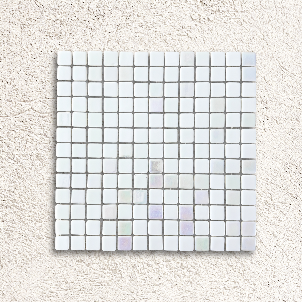 Niebla Mix-Iris Ernio white and silver glass mosaic sheet with subtle iridescent accents on a white textured background.