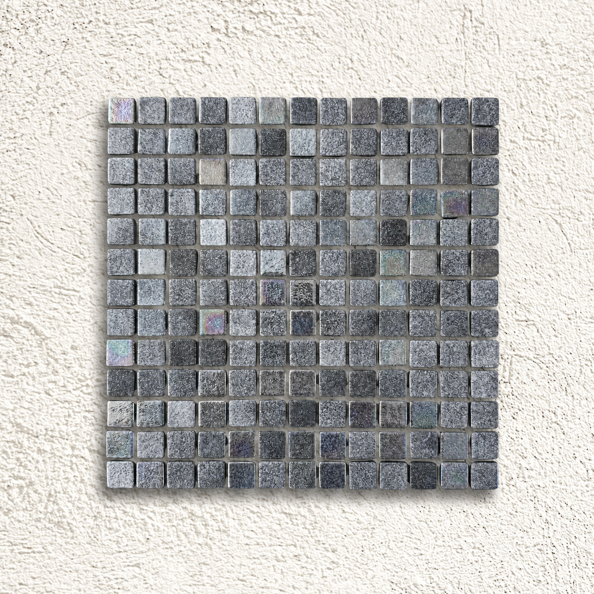 Niebla Mix-Iris Murray black and grey glass mosaic sheet with subtle iridescent highlights on a white textured background.
