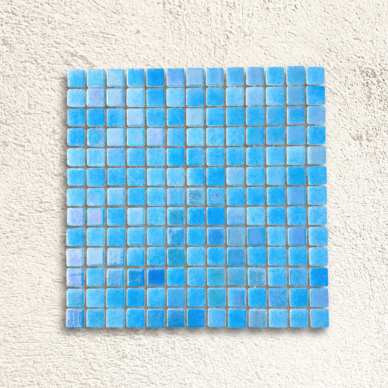 Niebla Mix-Iris Oria blue glass mosaic sheet with 25mm square tiles and iridescent highlights against a white textured background.