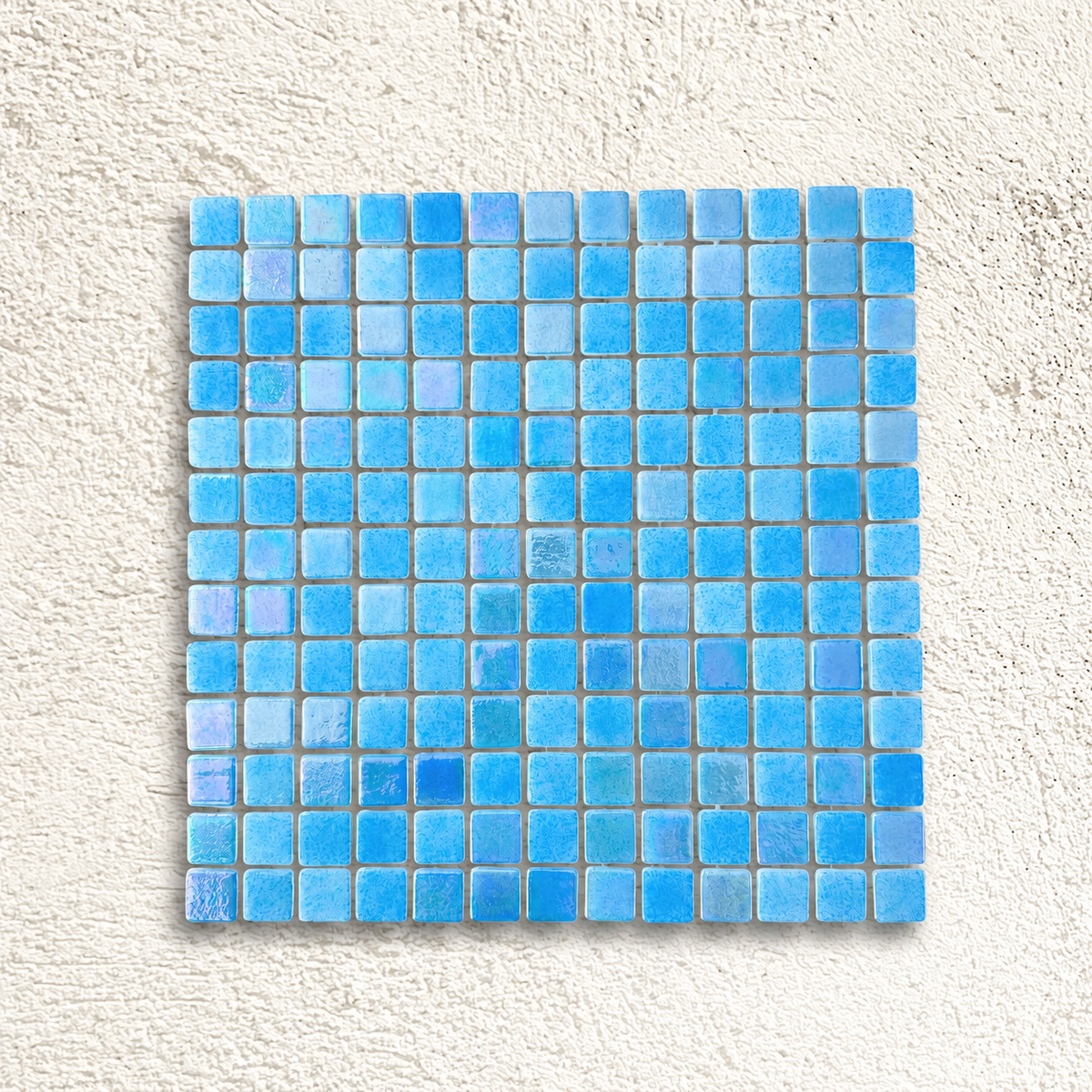 Niebla Mix-Iris Oria blue glass mosaic sheet with 25mm square tiles and iridescent highlights against a white textured background.