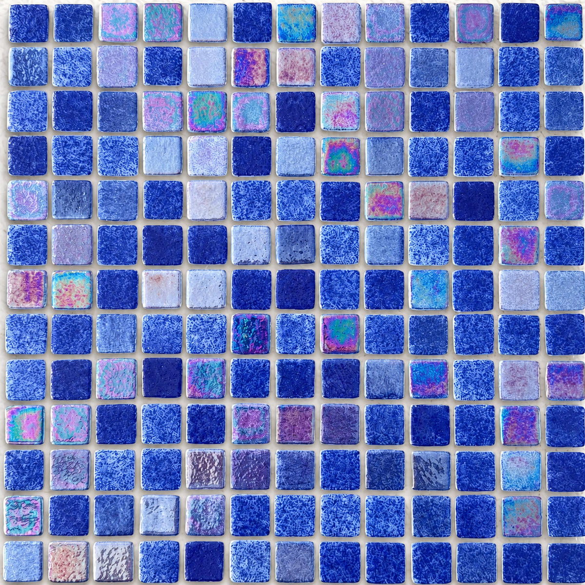 Close-up of Niebla Mix-Iris Urola mosaic tiles showing mottled blue glass and pink, lilac and teal lustre highlights.