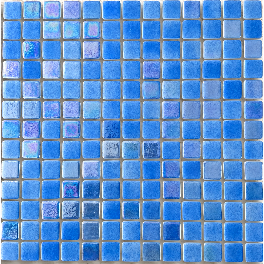 Detail of Niebla Mix-Iris Urumea square glass mosaics showing mottled blue tones and an iridescent lustre finish.