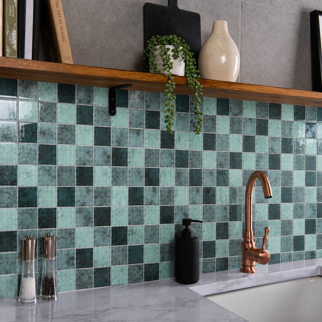 Raindrop Square Green Glass Mosaic kitchen splashback with grey grout, copper tap and wooden shelf.