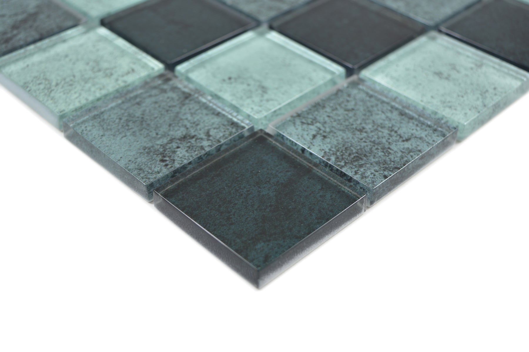 Close-up of Raindrop petrol and mint green glass mosaic tiles with translucent edges and fine speckled texture.