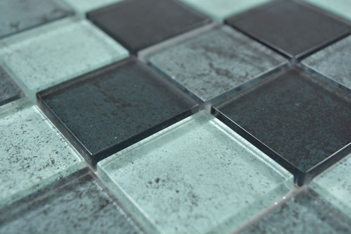 Angled view of Raindrop square green glass mosaic showing glossy surfaces, mottled detailing and 8mm thickness.