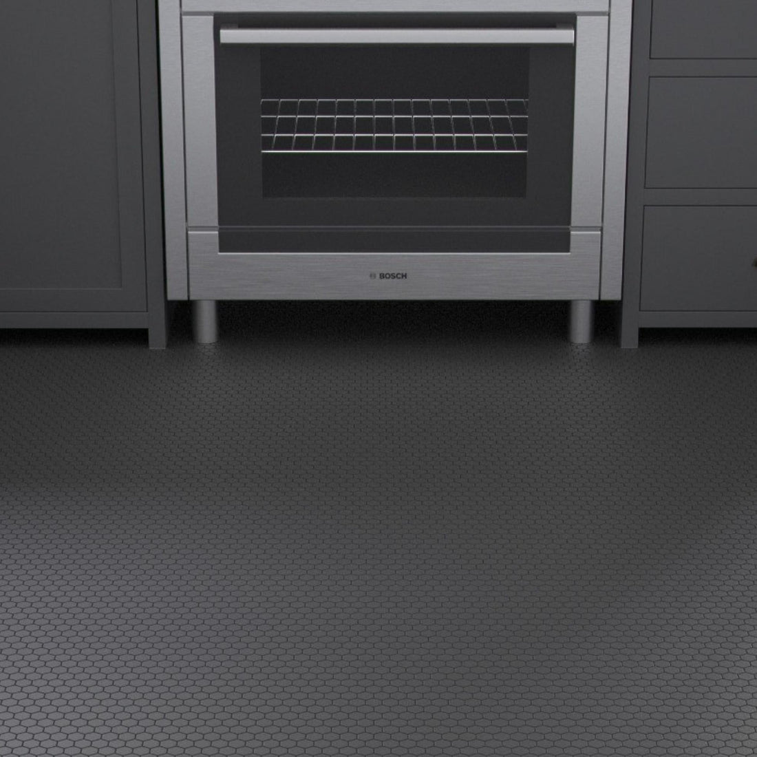 Black hexagon porcelain mosaic floor tiles in a dark contemporary kitchen with grey cabinetry and stainless steel oven.