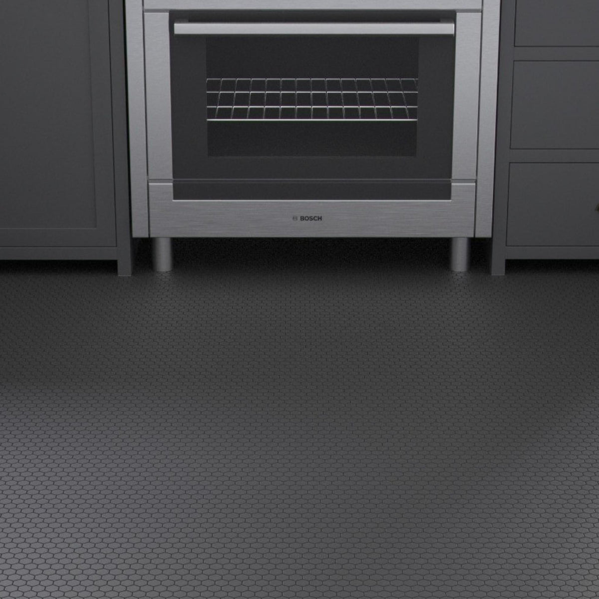 Black hexagon porcelain mosaic floor tiles in a dark contemporary kitchen with grey cabinetry and stainless steel oven.