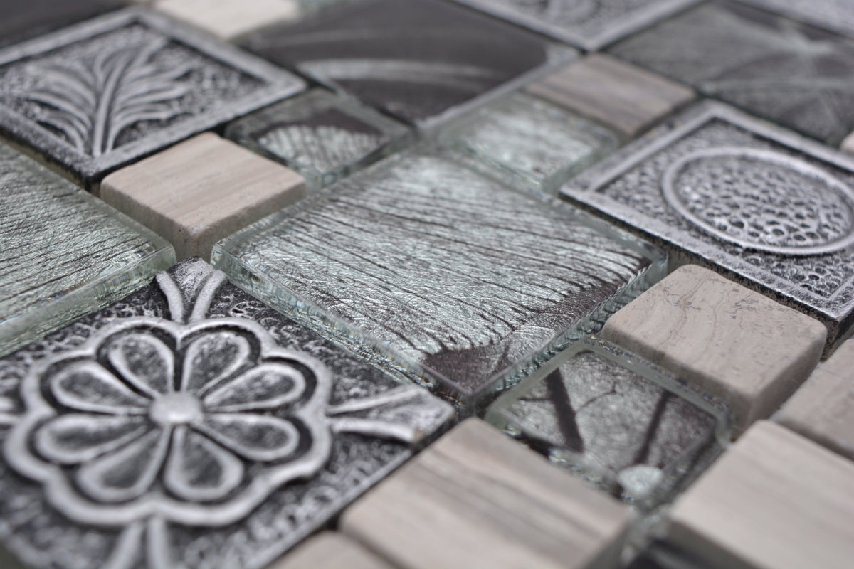 Detailed macro view of silver grey glass and resin mosaic with gloss, textured and decorative square inserts