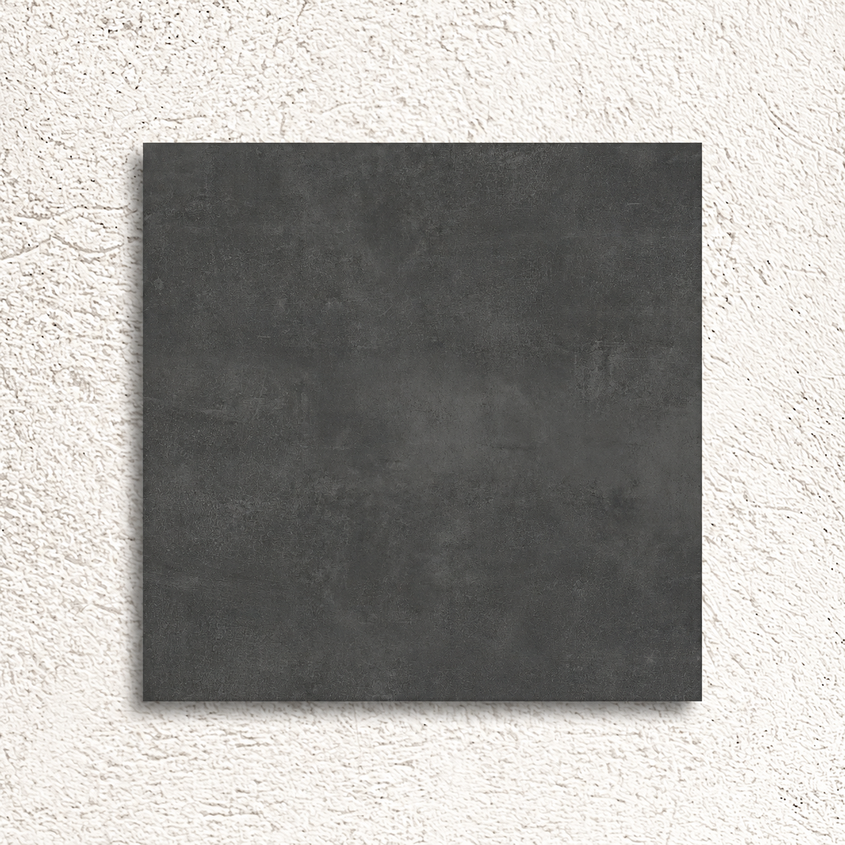 Stark Graphite 600×600mm concrete effect porcelain tile displayed against a textured white background.